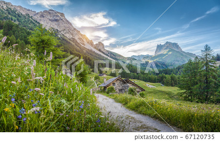Alpine scenery in the Dolomites with mountain hut at sunset Alpine scenery in the Dolomites with mountain hut at sunset 67120735