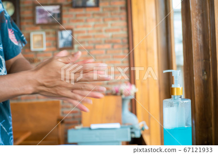 Man using alcohol gel for cleaning hands before Man using alcohol gel for cleaning hands before 67121933
