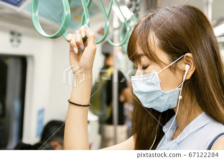 Young Asian woman passenger wearing surgical mask Young Asian woman passenger wearing surgical mask 67122284