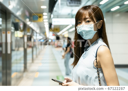 business woman wearing face mask at train station business woman wearing face mask at train station 67122287