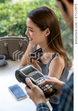 Asian customer make payment with contactless Asian customer make payment with contactless 67122975