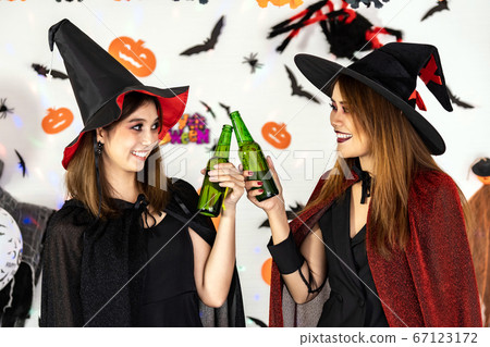 Asian women celebrate cheers in Halloween party 67123172