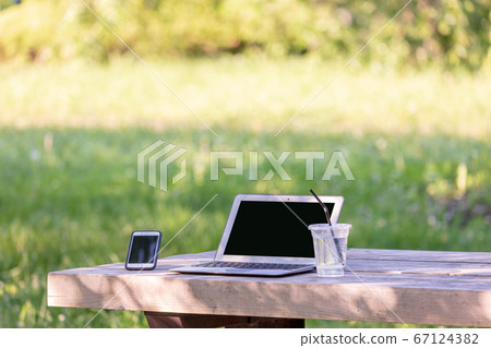 Telework on a park bench Telework on a park bench 67124382