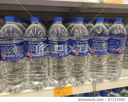 KUALA LUMPUR, MALAYSIA -APRIL 15, 2020: Mineral water is packaged and in plastic bottles and labelled with various brands. Displayed on a shelf inside a supermarket. 67125480