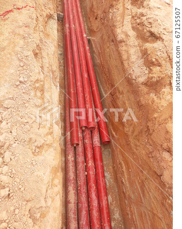 KUALA LUMPUR, MALAYSIA -APRIL 06, 2019: HDPE conduit pipe power conduit installed inside the ground trench. It is used to protect underground electrical and telecommunication cable.  67125507