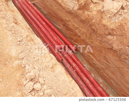 KUALA LUMPUR, MALAYSIA -APRIL 06, 2019: HDPE conduit pipe power conduit installed inside the ground trench. It is used to protect underground electrical and telecommunication cable.  67125508