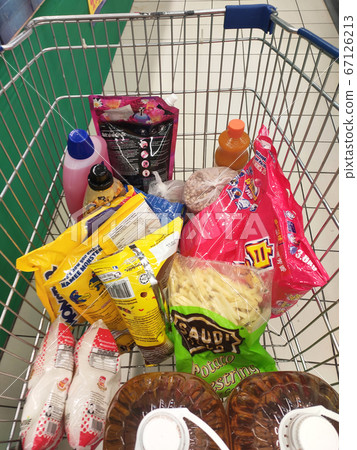 KUALA LUMPUR, MALAYSIA - MARCH 21, 2020: Groceries that have been picked up are placed in the cart before payment is made at the payment counter. Shopping carts make it easy for customers to shop. KUALA LUMPUR, MALAYSIA - MARCH 21, 2020: Groceries that have been picked up are placed in the cart before payment is made at the payment counter. Shopping carts make it easy for customers to shop. 67126213