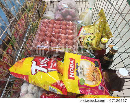 KUALA LUMPUR, MALAYSIA - MARCH 21, 2020: Groceries that have been picked up are placed in the cart before payment is made at the payment counter. Shopping carts make it easy for customers to shop. 67126217