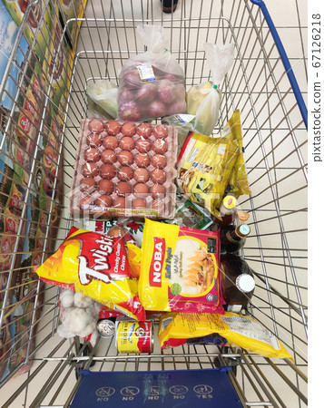 KUALA LUMPUR, MALAYSIA - MARCH 21, 2020: Groceries that have been picked up are placed in the cart before payment is made at the payment counter. Shopping carts make it easy for customers to shop. 67126218