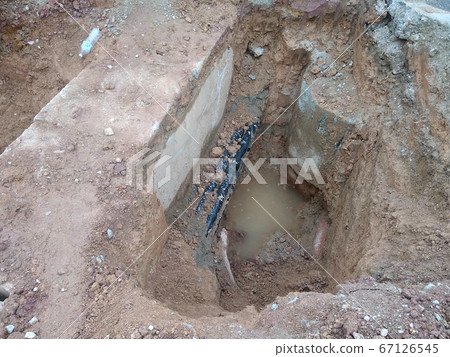 SEREMBAN, MALAYSIA -AUGUST 01, 2019: Underground utility and services pipe laid by workers in the trenches at the construction site. Installation of pipes still ongoing.     67126545