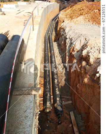 SEREMBAN, MALAYSIA -AUGUST 01, 2019: Underground utility and services pipe laid by workers in the trenches at the construction site. Installation of pipes still ongoing.     67126551
