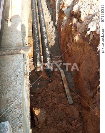 SEREMBAN, MALAYSIA -AUGUST 01, 2019: Underground utility and services pipe laid by workers in the trenches at the construction site. Installation of pipes still ongoing. SEREMBAN, MALAYSIA -AUGUST 01, 2019: Underground utility and services pipe laid by workers in the trenches at the construction site. Installation of pipes still ongoing. 67126552