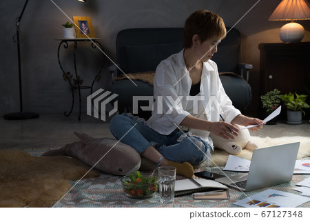 Asian woman in casual clothing using laptop working indoors at home Asian woman in casual clothing using laptop working indoors at home 67127348