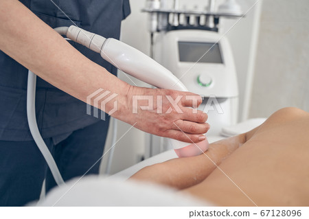 Woman tightening skin with special beauty procedures in the clinic 67128096