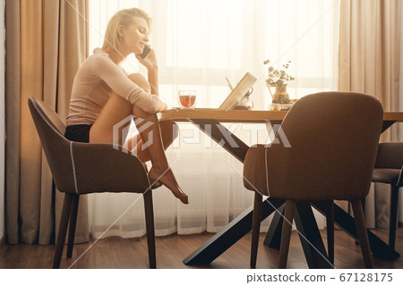 Caucasian female teleworker making a phone call 67128175