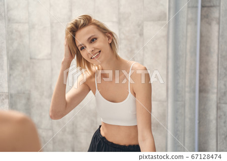 Woman in underwear standing in the bathroom Woman in underwear standing in the bathroom 67128474