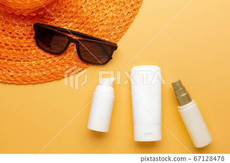 Set of sunblock moisturizer and spray to protect from sunlight on the beach 67128478