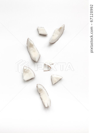 Coconuts pieces on white table , top view, flat 67128992