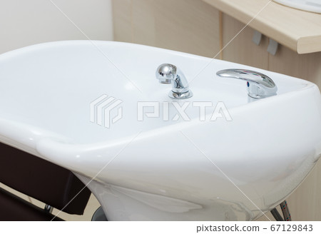 white sink in modern hairdressing salon 67129843