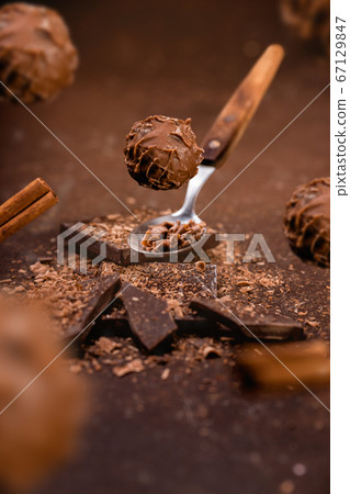 levitated chocolate pralines ON BROWN GROUNGE BACKGROUND 67129847