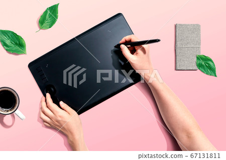 Person using a graphic pen tablet 67131811
