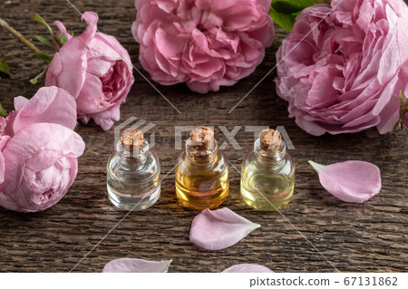 Three bottles of essential oil with rose de mai Three bottles of essential oil with rose de mai 67131862
