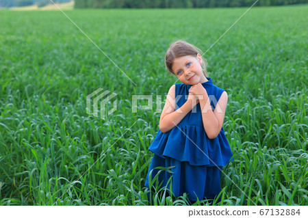 Beautiful little girl runs in the summer field Beautiful little girl runs in the summer field 67132884