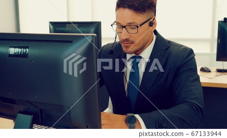 Business people wearing headset working in office 67133944