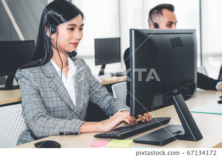 Business people wearing headset working in office 67134172