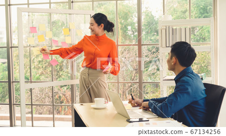 Business people work on project planning board 67134256