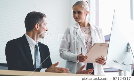 Two business people talk project strategy at office Two business people talk project strategy at office 67134517
