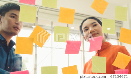 Business people work on project planning board 67134671