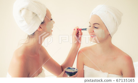 Beautiful woman having a facial treatment at spa. 67135165