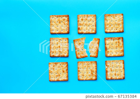 Crackers with sugar on blue background. Crackers with sugar on blue background. 67135384