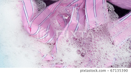 Color clothes soak in powder detergent water 67135390