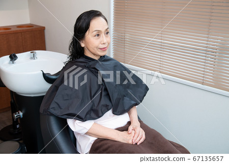 Senior woman doing hair care in a beauty salon 67135657