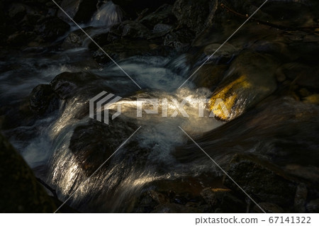Sunlight through the river 67141322
