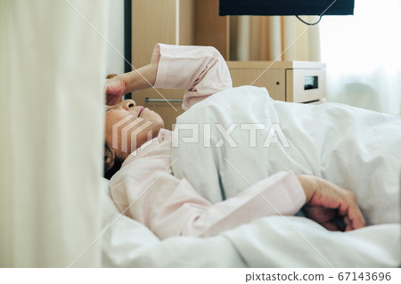 Woman lying in bed at hospital [hospital] 67143696