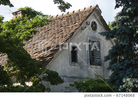 Attic tiled roof of an old house, window with Attic tiled roof of an old house, window with 67148068