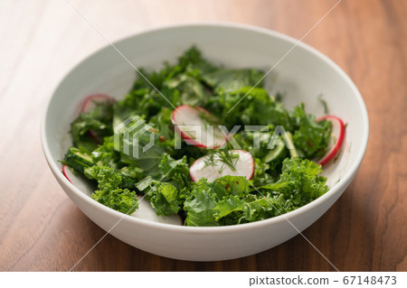 Summer fresh salad with radish, cucumber and herbs in white bowl 67148473