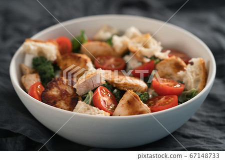Caesar salad alternative with kale and turkey in white bowl Caesar salad alternative with kale and turkey in white bowl 67148733