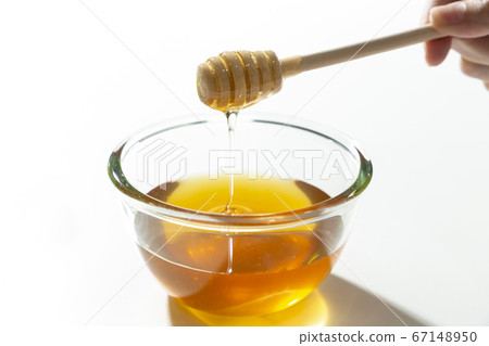 Fresh honey bee in bowl on white background. 67148950
