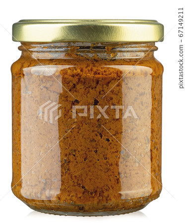 Closeup of jar with dried tomatoes pesto. 67149211