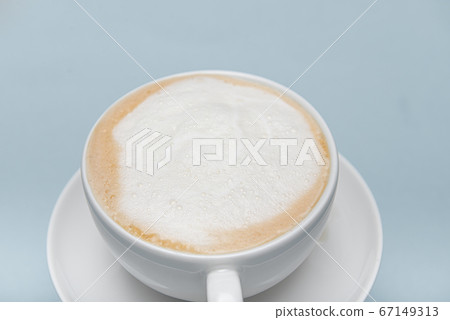 part of white cappuccino cup isolated on a blue background with a place for text 67149313