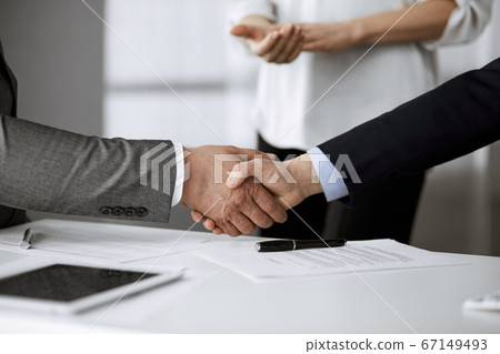 Business people shaking hands finishing contract signing, close-up. Business communication concept. Handshake and marketing Business people shaking hands finishing contract signing, close-up. Business communication concept. Handshake and marketing 67149493