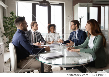Multiracial employees gather in boardroom engaged in team discussion 67149835