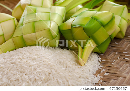 ketupat casing and rice in bamboo container. ketupat casing and rice in bamboo container. 67150667