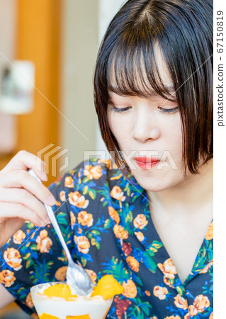 Woman eating parfait in cafe Woman eating parfait in cafe 67150819
