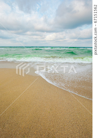 sea tide on a cloudy evening. waves crashing sandy sea tide on a cloudy evening. waves crashing sandy 67151562