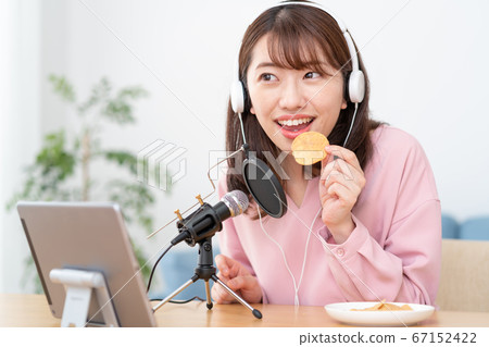 在YouTube上傳遞咀嚼聲音的年輕女子 在YouTube上傳遞咀嚼聲音的年輕女子 67152422